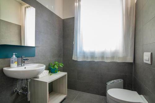 a bathroom with a sink and a toilet at Casa a Colori Padova in Padova