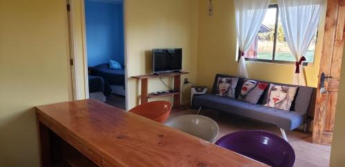 a living room with a couch and a table at Arquería Patagonia Lodge in Puerto Varas