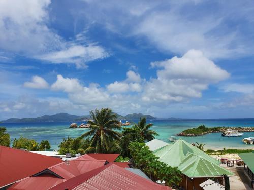 a view of a beach with boats in the water at Bord Mer City Apartments in La Digue