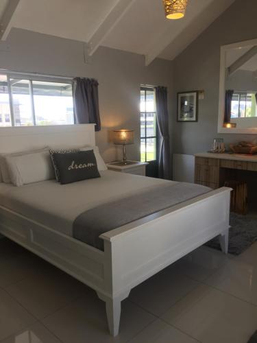 a bedroom with a large white bed in a room at Man And Tree House NO load shedding in Cape Town
