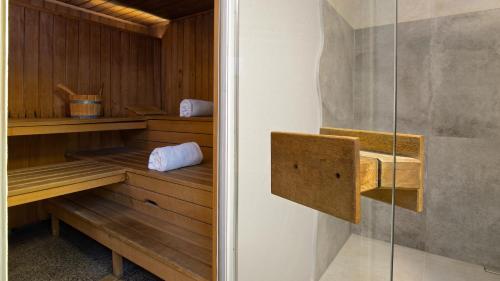 a sauna with wooden shelves and a glass door at Hotel-Restaurant Barbarossahof in Kaiserslautern
