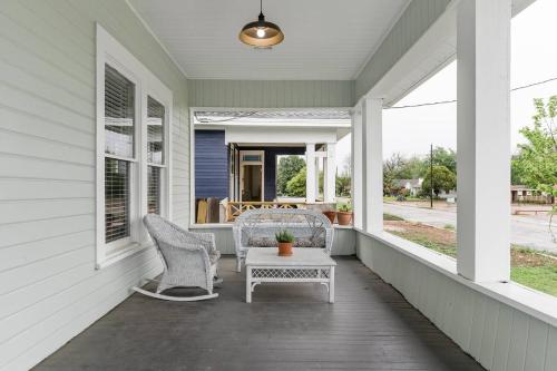 a porch with two chairs and a table at Restored 1930s Uptown Bungalow 2 min. to Magnolia in Waco
