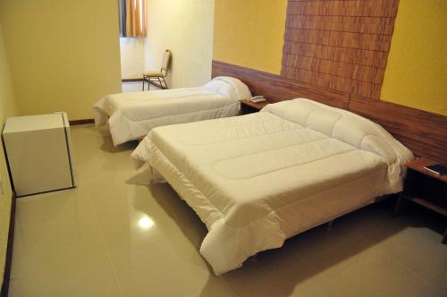 En eller flere senger på et rom på Hotel da Montanha