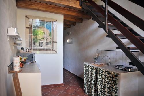 a kitchen with a sink and a staircase in a room at Il Giardino Del Barocco in Noto