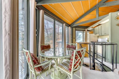 a dining room with a glass table and chairs at Slopesider 01 in Sugar Mountain
