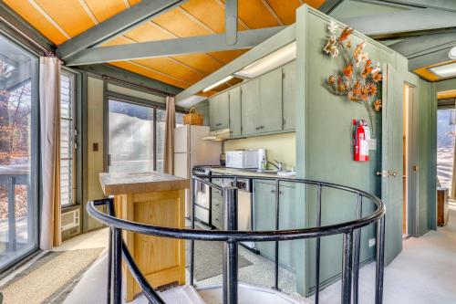 a kitchen with a round table in a tiny house at Slopesider 01 in Sugar Mountain