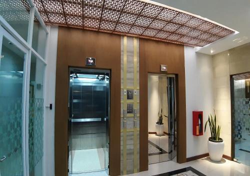 a lobby with a shower and a glass door at Apartemen Taman Melati Yogyakarta by ArFe Room in Sleman