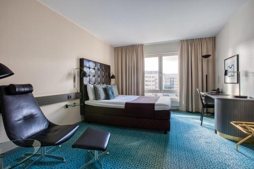 una camera d'albergo con letto, scrivania e sedia di Memory Hotel a Stoccolma