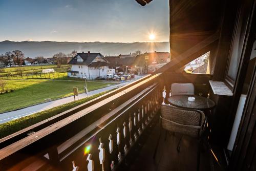 a balcony with a table and a view of a street at Guesthouse Leski Dvor in Lesce