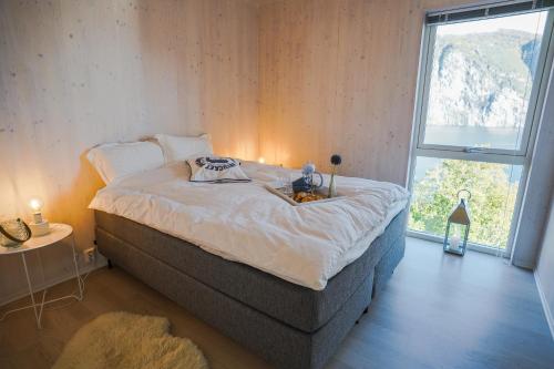 a bedroom with a bed and a large window at Fjord View Apartment in Stranda
