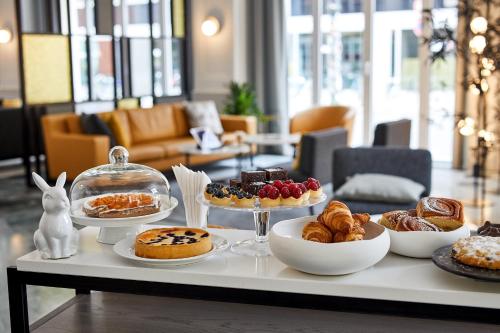 a table with various pastries and desserts on it at Classik Hotel Alexander Plaza in Berlin