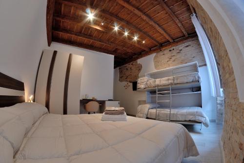a large bedroom with two beds and an archway at B&B DEL CORSO in Loreto