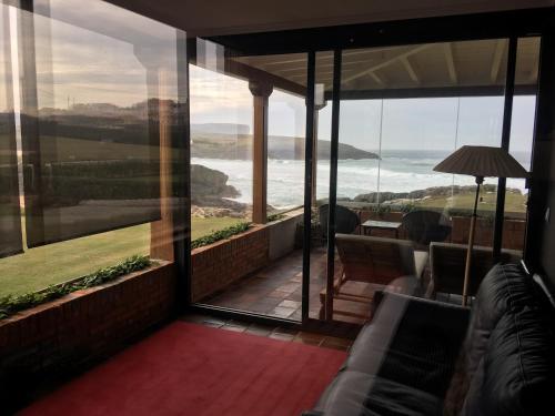 a room with a balcony with a view of the ocean at La Lagartija Adults Only in Ajo