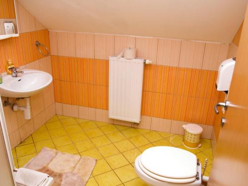 a bathroom with a toilet and a sink at Guest House Pri Treh Lipah in Ptuj