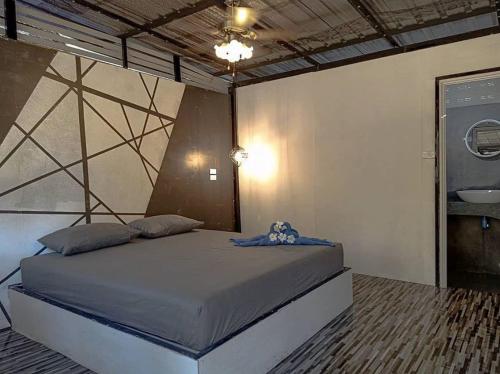 a bedroom with a large bed in a room at Ozone Beach Huts in Ko Lanta