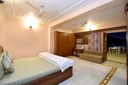 a bedroom with a bed and a window with a table at Pink Elephant, Jaipur in Jaipur
