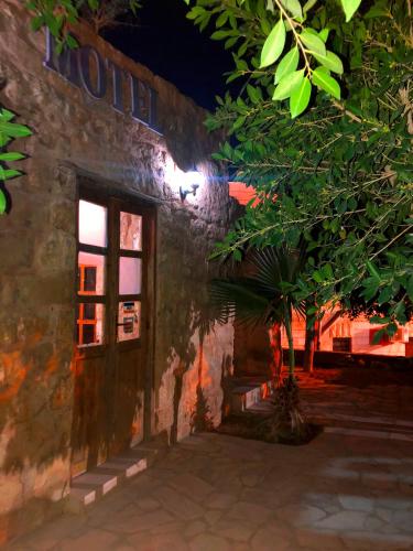 a door to a building with a tree in front of it at The Orient Home in Wadi Musa