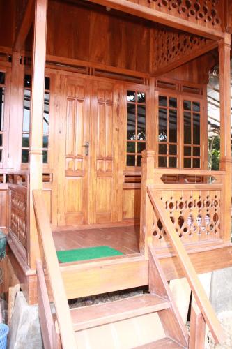 an inside view of a room with wooden walls and doors at Bantal Guling Villa in Lembang