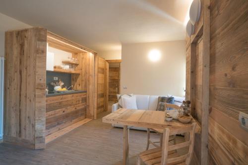 a room with wooden walls and a wooden table at Al Baitin - Charme & Nature - in Santa Caterina Valfurva