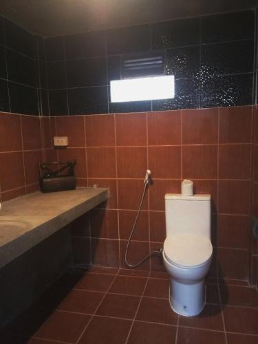 a bathroom with a toilet and a sink at T&P at Pai in Pai