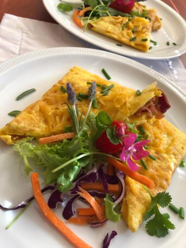 two plates of food on a white plate at La Bella B&B Under The Fig Tree in Bela-Bela