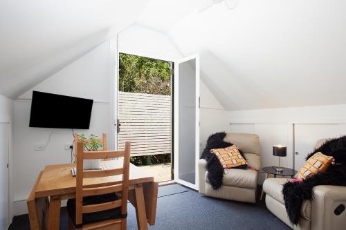 a living room with a couch and a table at Woolwich Studio Bliss, Private Oasis by the Water in Sydney