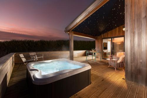 a jacuzzi tub on the deck of a house at Charterhouse, Strawberryfield Park in Cheddar