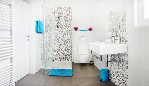 a bathroom with a shower and a toilet and a sink at Holiday Home Amazing View in Piran
