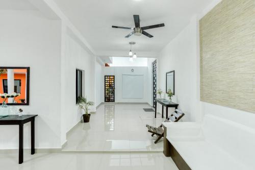 a hallway with white walls and a ceiling fan at Hotel Casa Ariana in Bacalar