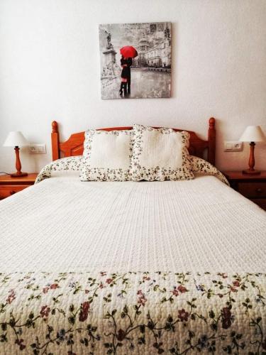 a bedroom with a bed with a red umbrella at Casa Chiki in Vera