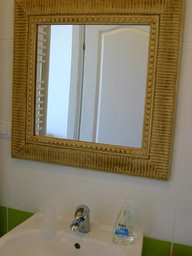 a bathroom with a mirror and a sink at Rooms Medved in Samobor
