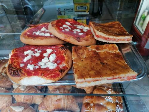 a display case with different types of bread and pastries at BeBaSu in Naples