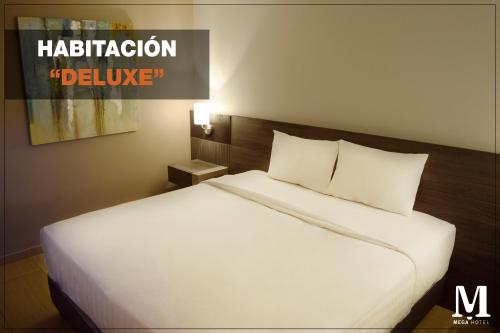 a large white bed in a hotel room at Hotel Mega in Lima