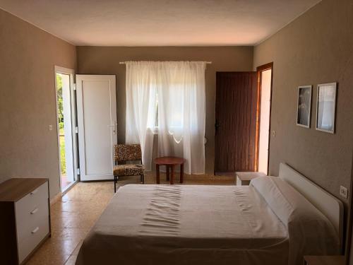 a bedroom with a bed and a door with a window at Villa tosalet in Jávea