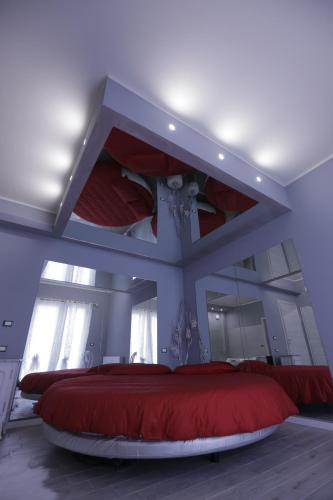 a bedroom with a large red bed in a room at Cupido da Simona in Ostellato