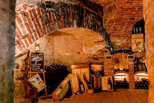 a room with a bunch of bottles of wine at Gasthof Bräuer - Familie Eibensteiner in Weißkirchen in Steiermark