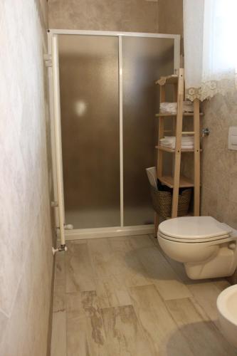 a bathroom with a toilet and a glass shower stall at B&B VILLA IOLANDA un soggiorno in Relax vista Mare e Montagna in Fossacesia
