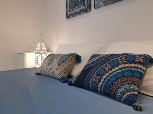 a bed with two pillows on top of it at L'Etoile in Foggia
