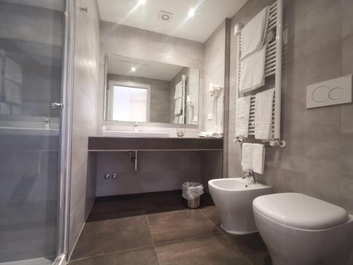 a bathroom with a toilet and a sink and a shower at L'Etoile in Foggia