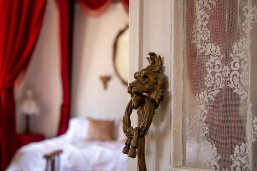 a door with a gargoyle on it next to a bedroom at Bisbee Grand Hotel in Bisbee