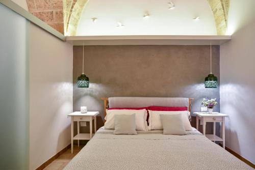 En eller flere senge i et værelse på Dimora Cardinale