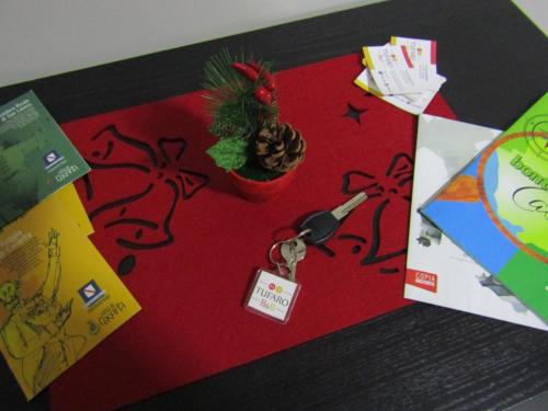 a christmas card with a potted plant and a pair of scissors at Tufaro B&B Private Room in Macerata Campania
