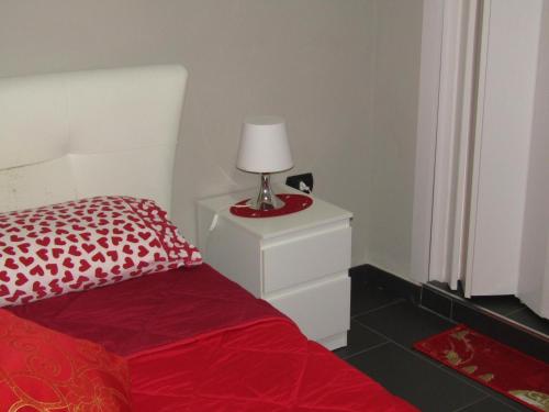 a bedroom with a bed and a lamp on a night stand at Tufaro B&B Private Room in Macerata Campania