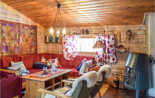 a living room with a red couch and a table at Cozy Home In Rauland With Wifi in Rauland