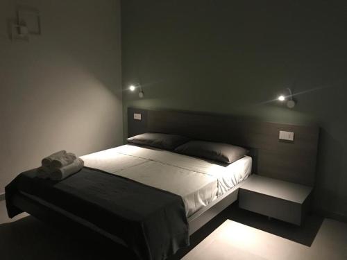 a bedroom with a bed in a dark room at B&Benny in Reggio Calabria