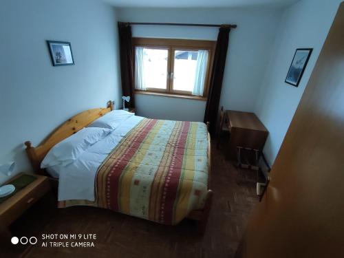 Кровать или кровати в номере Appartamenti Alpi