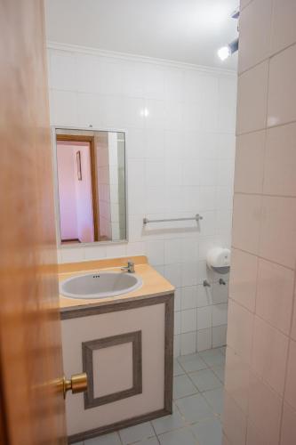 a bathroom with a sink and a mirror at Cabañas Maihue in La Serena