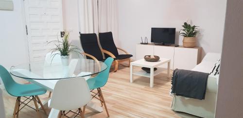 a dining room with a glass table and chairs at Casa Angy 3 in Zahora