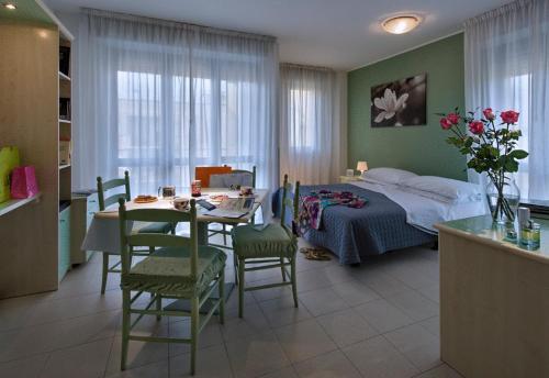 a bedroom with a bed and a table and chairs at Residence Viale Venezia in Verona