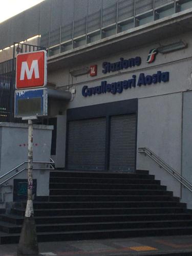 a building with a sign for a car dealership at COSTA APARTMENT NAPLES in Naples